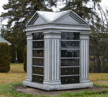 A grey columbarium on grass