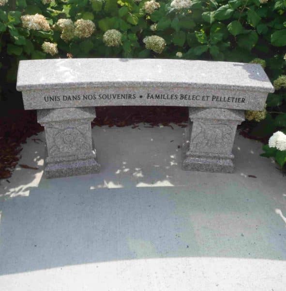 A grey commemorative bench