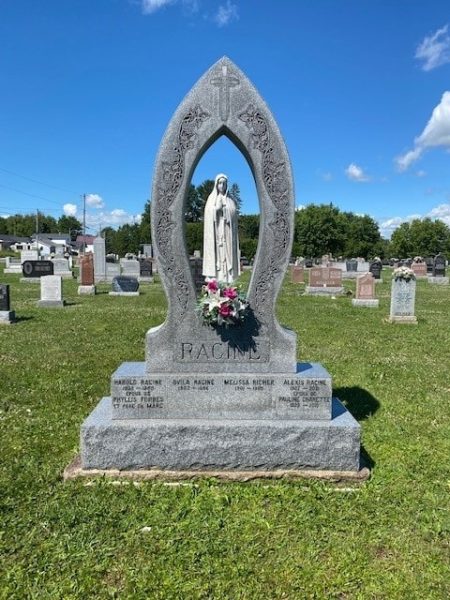 A grey catholic funeral monument with Maria
